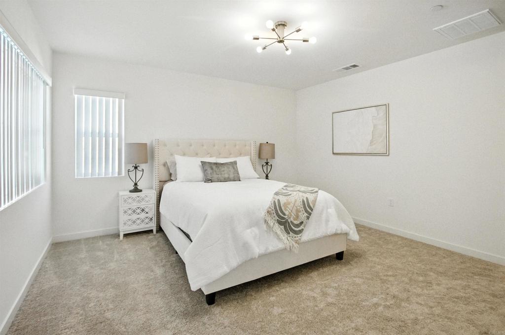 332 Seedling Way Fallbrook, CA 92028 - Photo 21 of 37 a bedroom with a bed and a chandelier