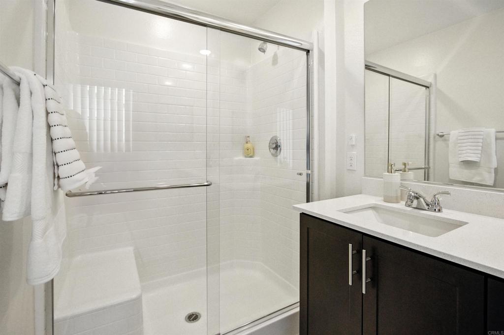 332 Seedling Way Fallbrook, CA 92028 - Photo 25 of 37 a bathroom with a shower sink and mirror