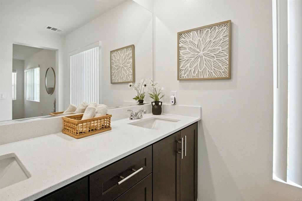 332 Seedling Way Fallbrook, CA 92028 - Photo 26 of 37 a bathroom with a sink and a mirror