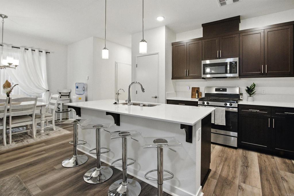 332 Seedling Way Fallbrook, CA 92028 - Photo 3 of 37 a kitchen with a sink appliances and cabinets