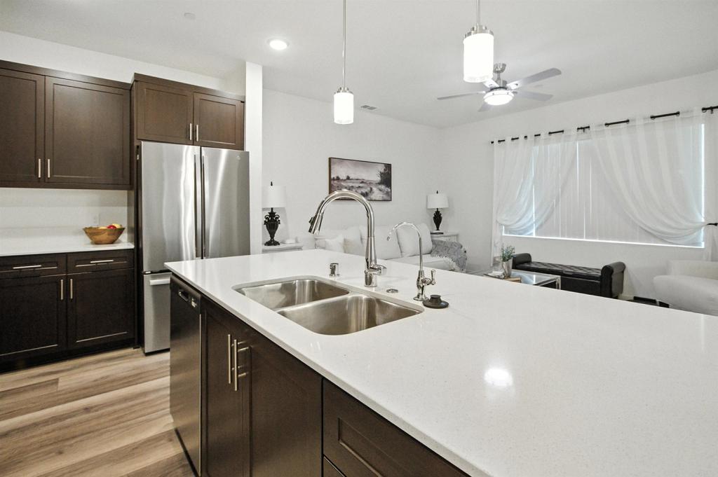332 Seedling Way Fallbrook, CA 92028 - Photo 6 of 37 a kitchen with stainless steel appliances a sink and a refrigerator