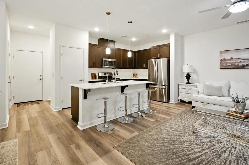 332 Seedling Way Fallbrook, CA 92028 - Photo 7 of 37 a kitchen with stainless steel appliances a stove a refrigerator and a sink