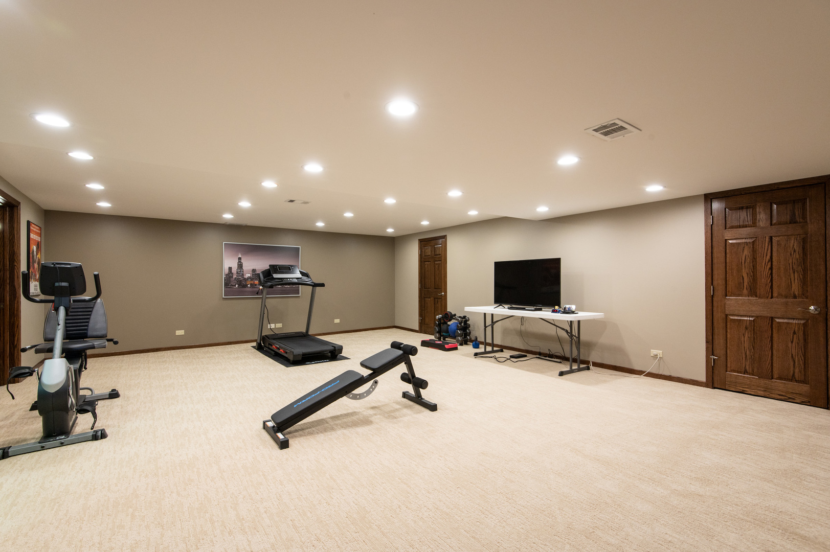 13530 South Monaghan Road Homer Glen, IL 60491 - Photo 32 of 45 a view of a room with gym equipment and a flat screen tv