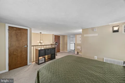 a bedroom with a bed and a chair