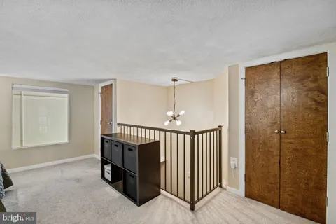 a view of a hallway with entryway door front door