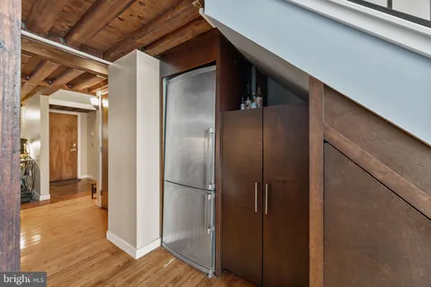 a view of closet area with wooden floor