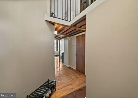 a view of entryway and hall with wooden floor