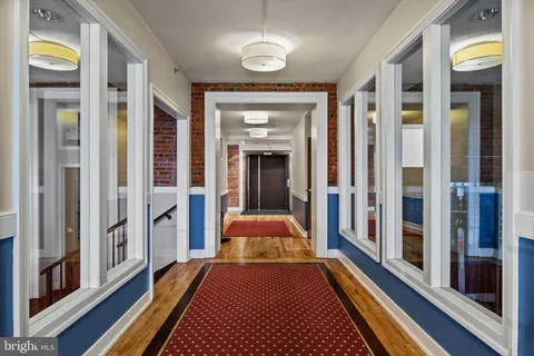 a view of a livingroom with wooden floor and a window