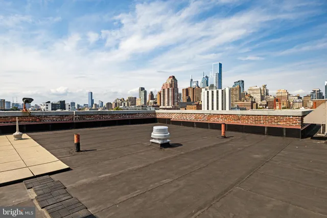 a roof deck with a table and chairs