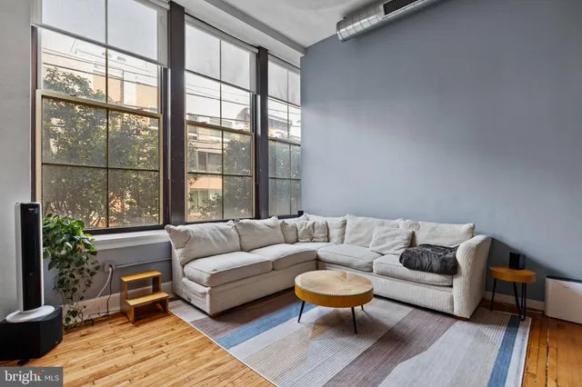 a living room with furniture and a large window