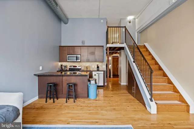 a kitchen with table chairs and wooden floor