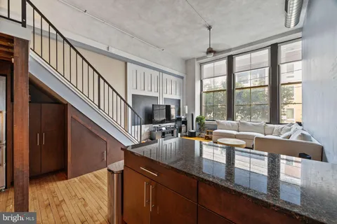 a living room with furniture windows and a flat screen tv