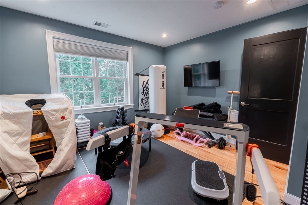 38 Cherry Street, Unit B Hudson, MA 01749 - Photo 29 of 33 a room with furniture a flat screen tv and a window