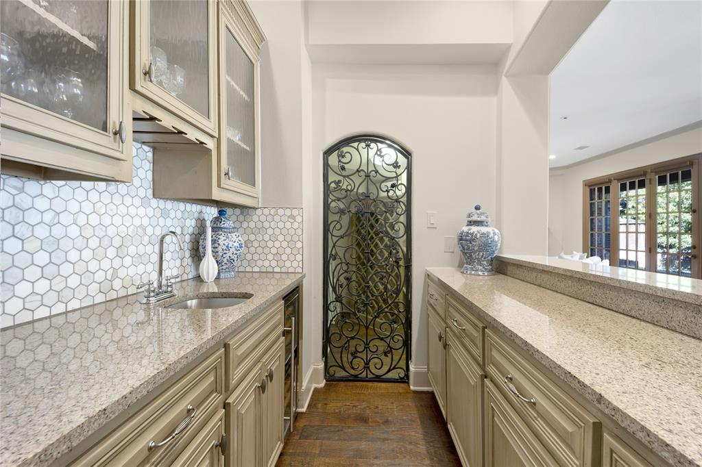 6615 Meadow Road Dallas, TX 75230 - Photo 13 of 39 The wet bar has a chilled wine fridge and wine room with storage for your favorite vintages.