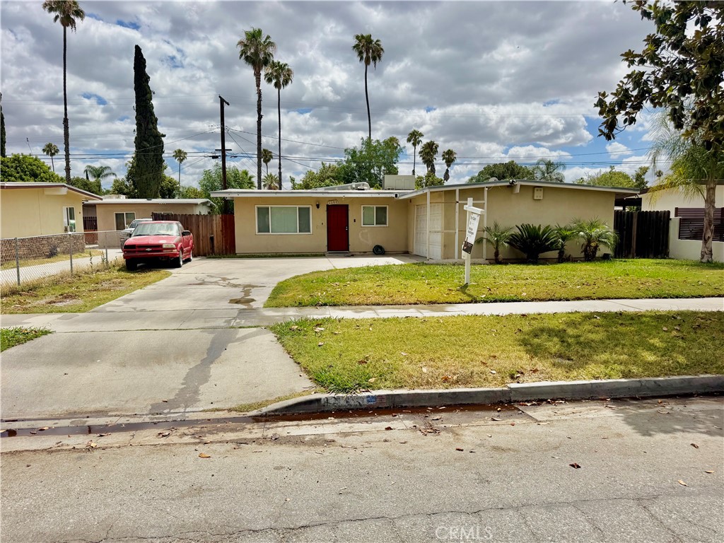 6688 Phoenix Avenue Riverside, CA 92504 - Photo 2 of 26 a view of a house with a yard and garage