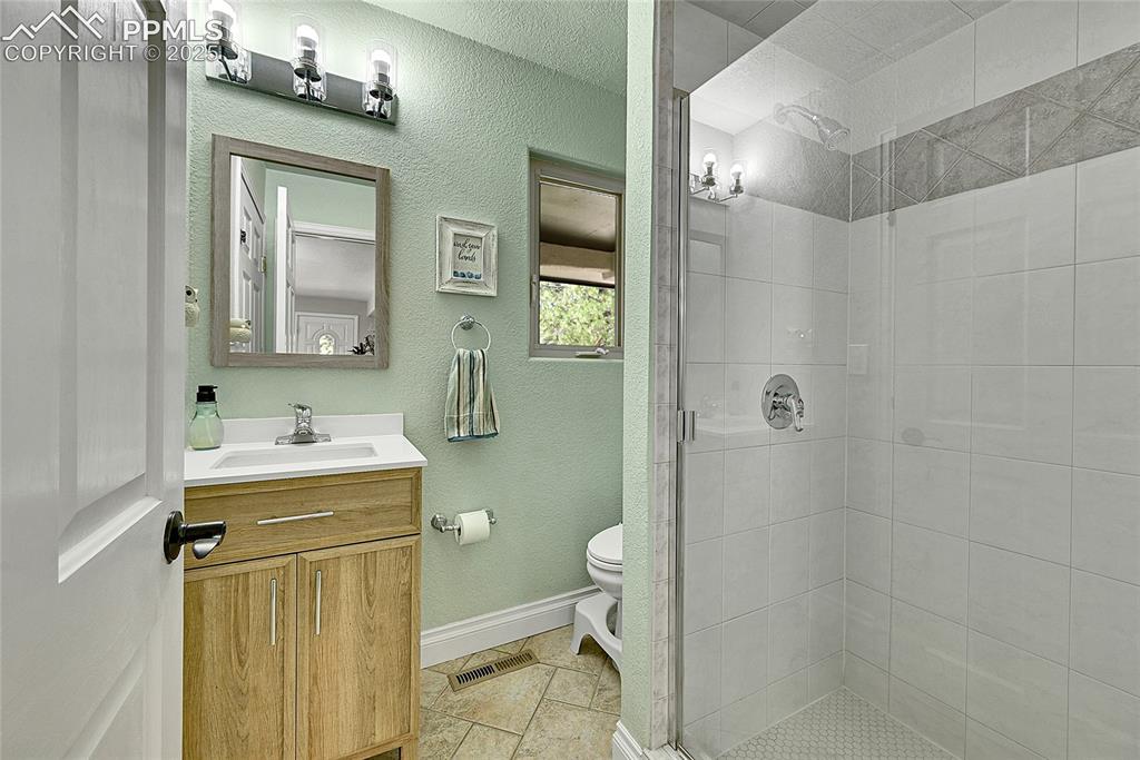 17350 Goshawk Road Colorado Springs, CO 80908 - Photo 26 of 50 a bathroom with a sink a toilet and shower