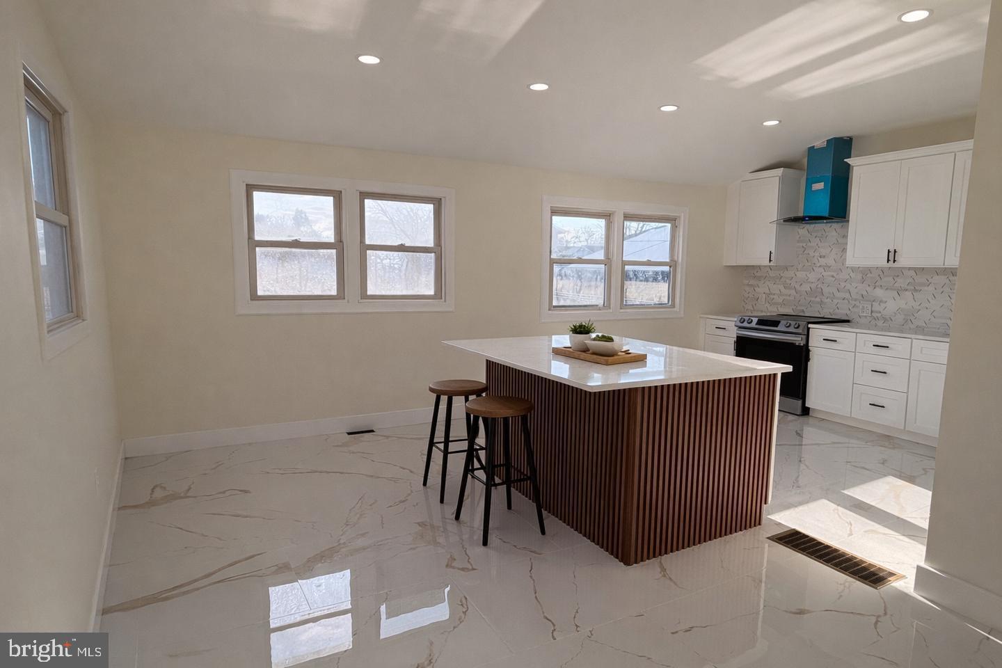 306 Cambridge Road Cherry Hill, NJ 08034 - Photo 2 of 13 a kitchen with granite countertop a sink a stove a microwave a counter top space and cabinets