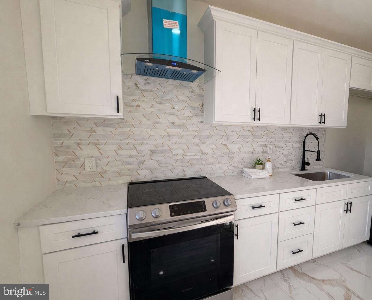 306 Cambridge Road Cherry Hill, NJ 08034 - Photo 3 of 13 a kitchen with white cabinets and appliances