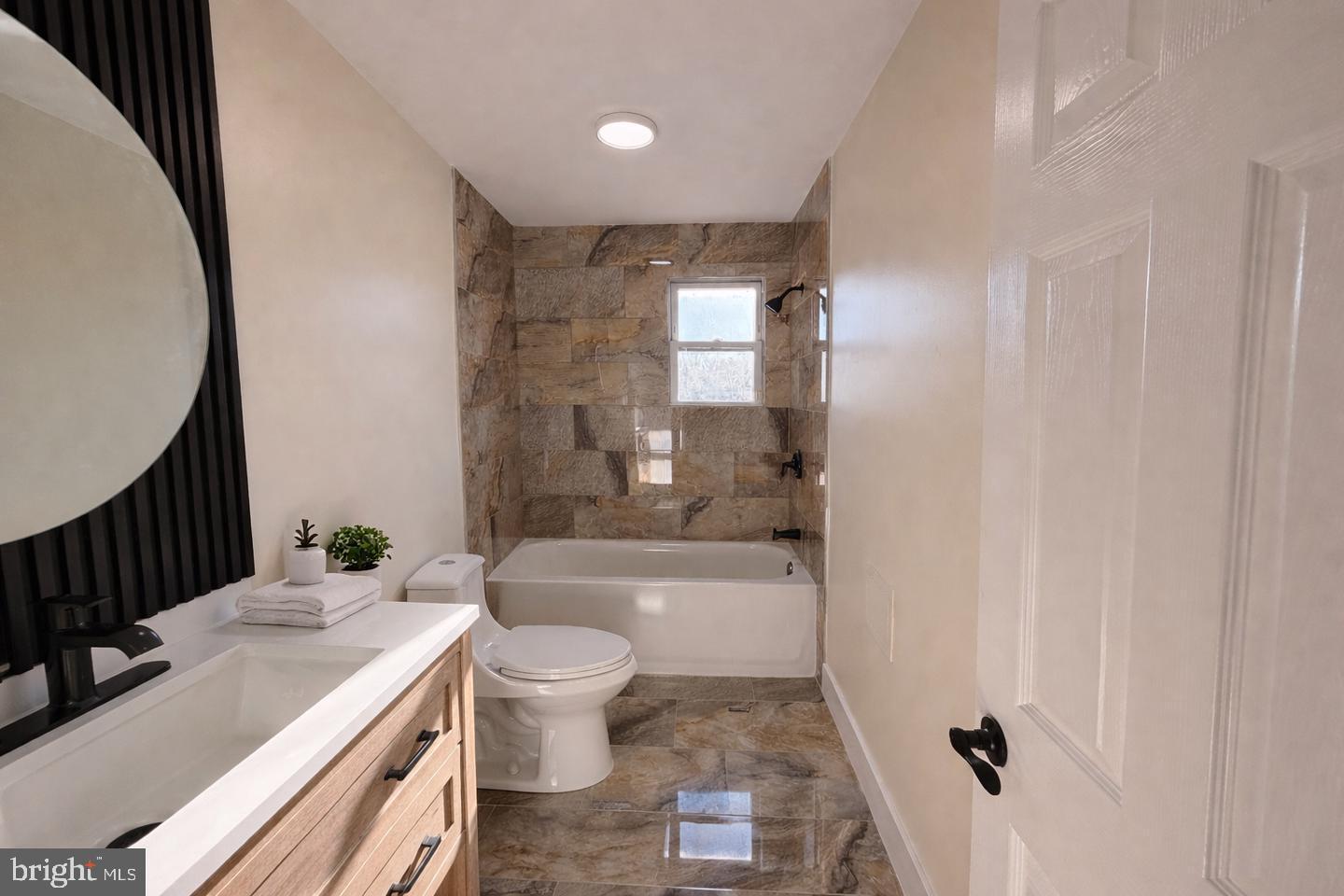 306 Cambridge Road Cherry Hill, NJ 08034 - Photo 8 of 13 a bathroom with a sink a toilet a mirror and bathtub