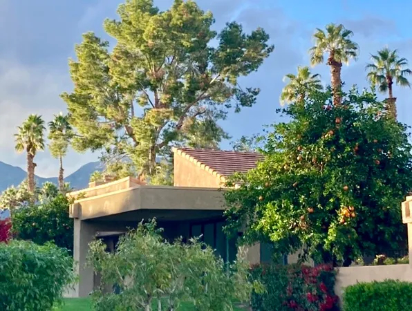 an aerial view of house with yard and seating space