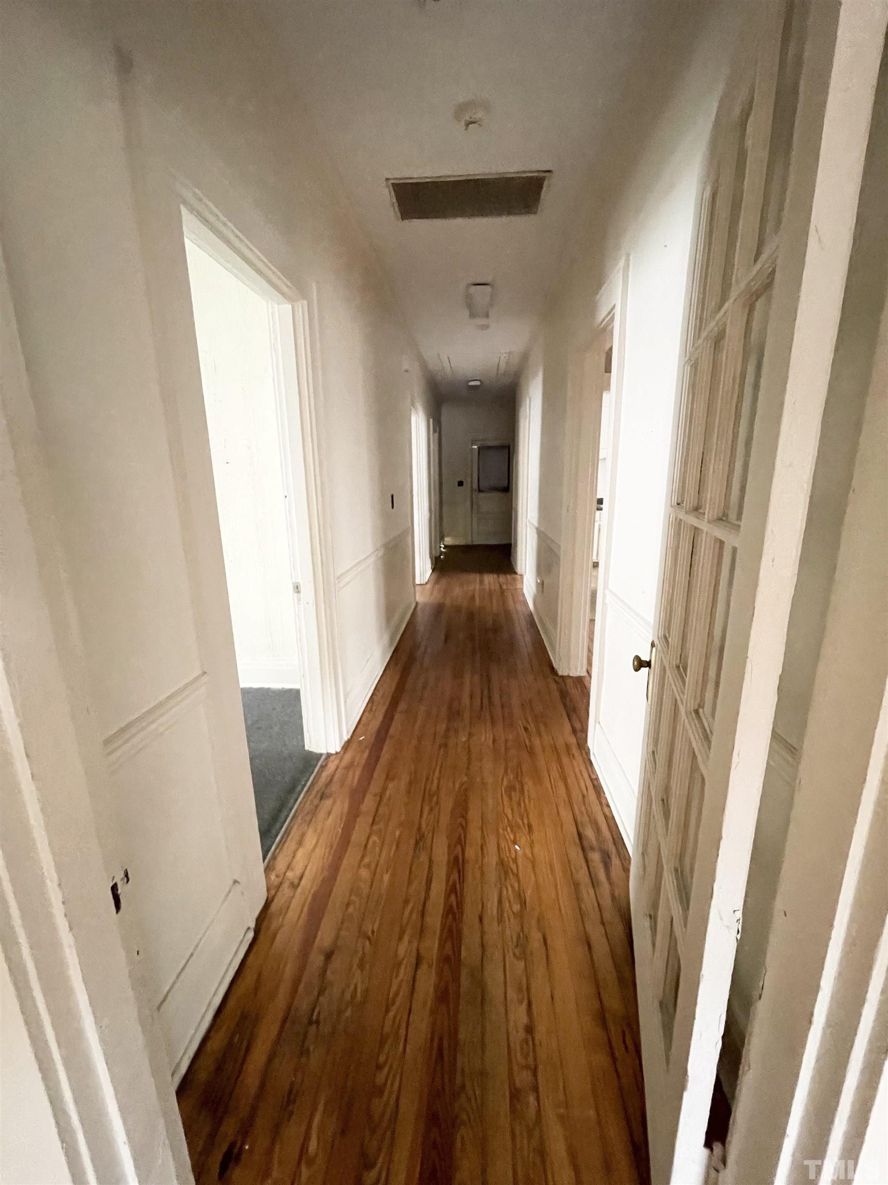 1005 Anderson Street Northwest Wilson, NC 27893 - Photo 12 of 16 a view of a hallway with wooden floor and staircase