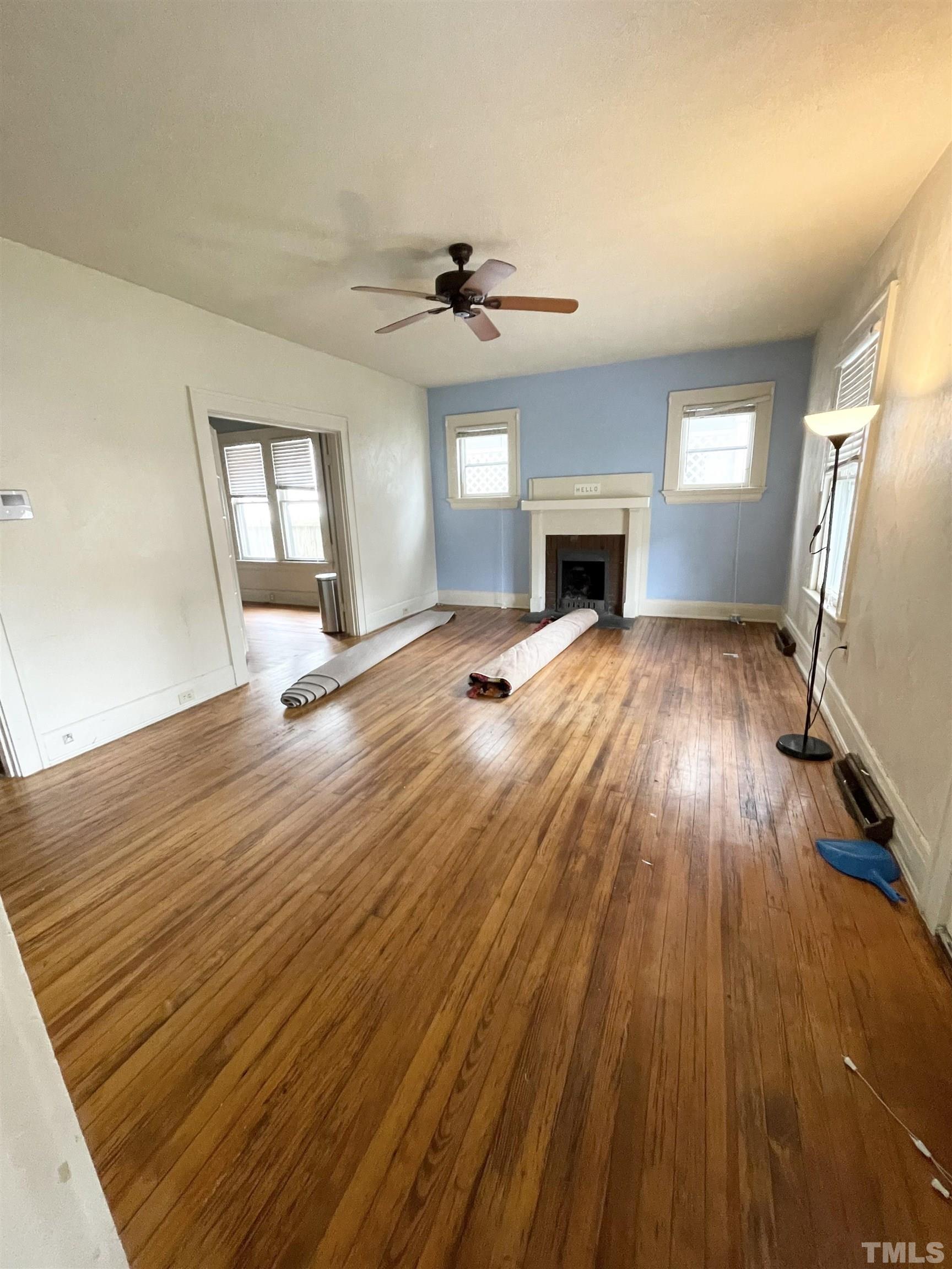 1005 Anderson Street Northwest Wilson, NC 27893 - Photo 14 of 16 wooden floor in an empty room with a fireplace