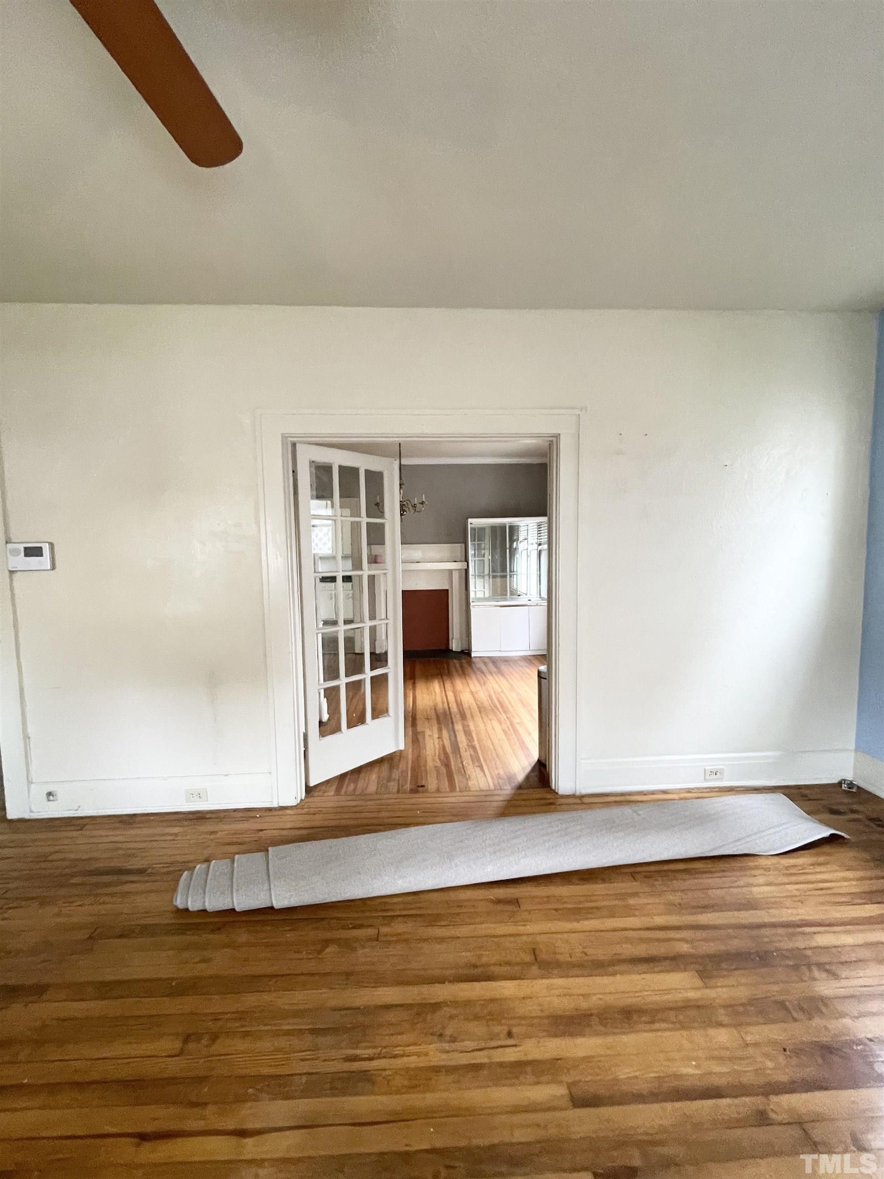 1005 Anderson Street Northwest Wilson, NC 27893 - Photo 2 of 16 a view of an empty room with wooden floor and a window