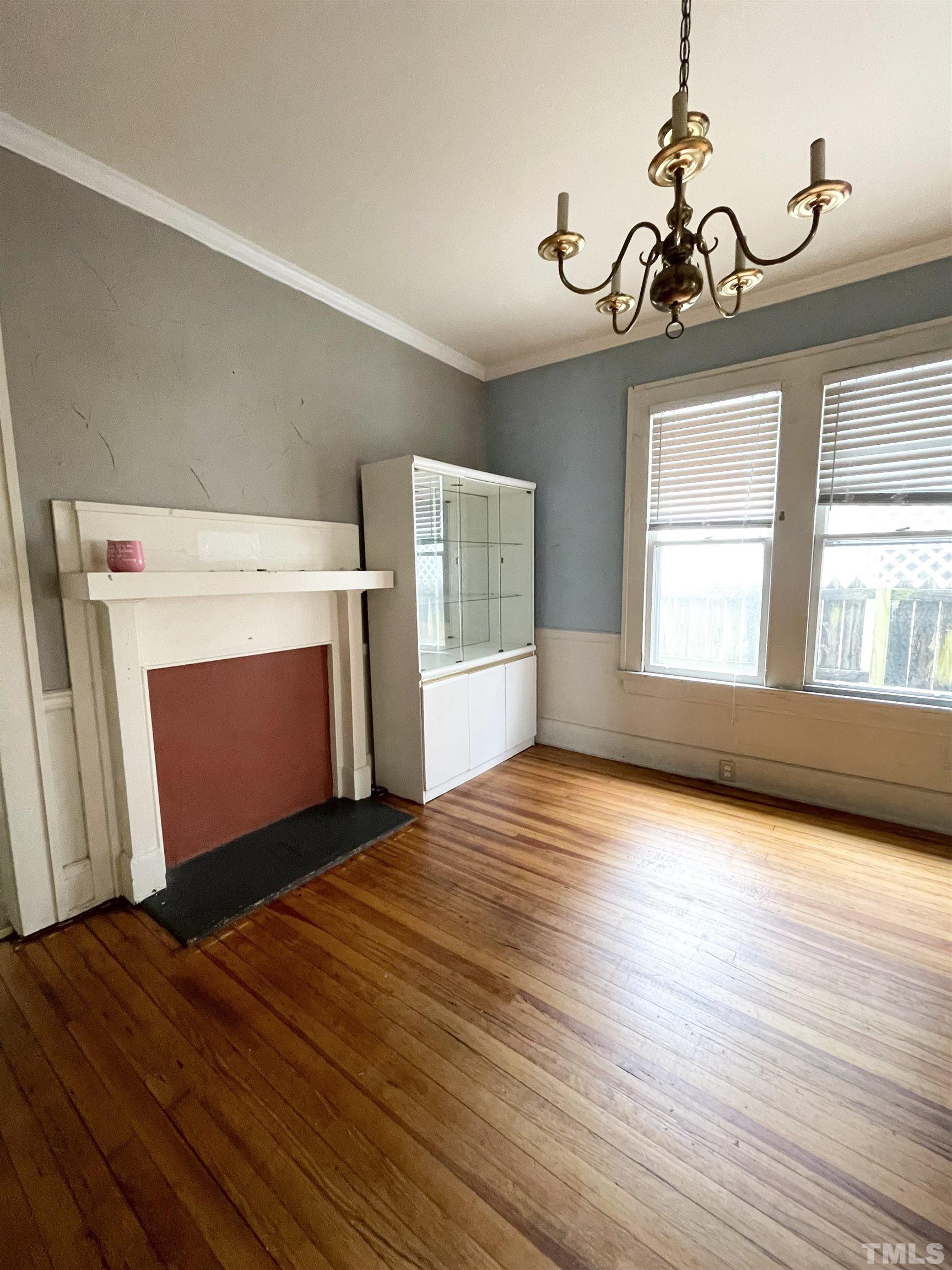 1005 Anderson Street Northwest Wilson, NC 27893 - Photo 3 of 16 a view of empty room with wooden floor and fan