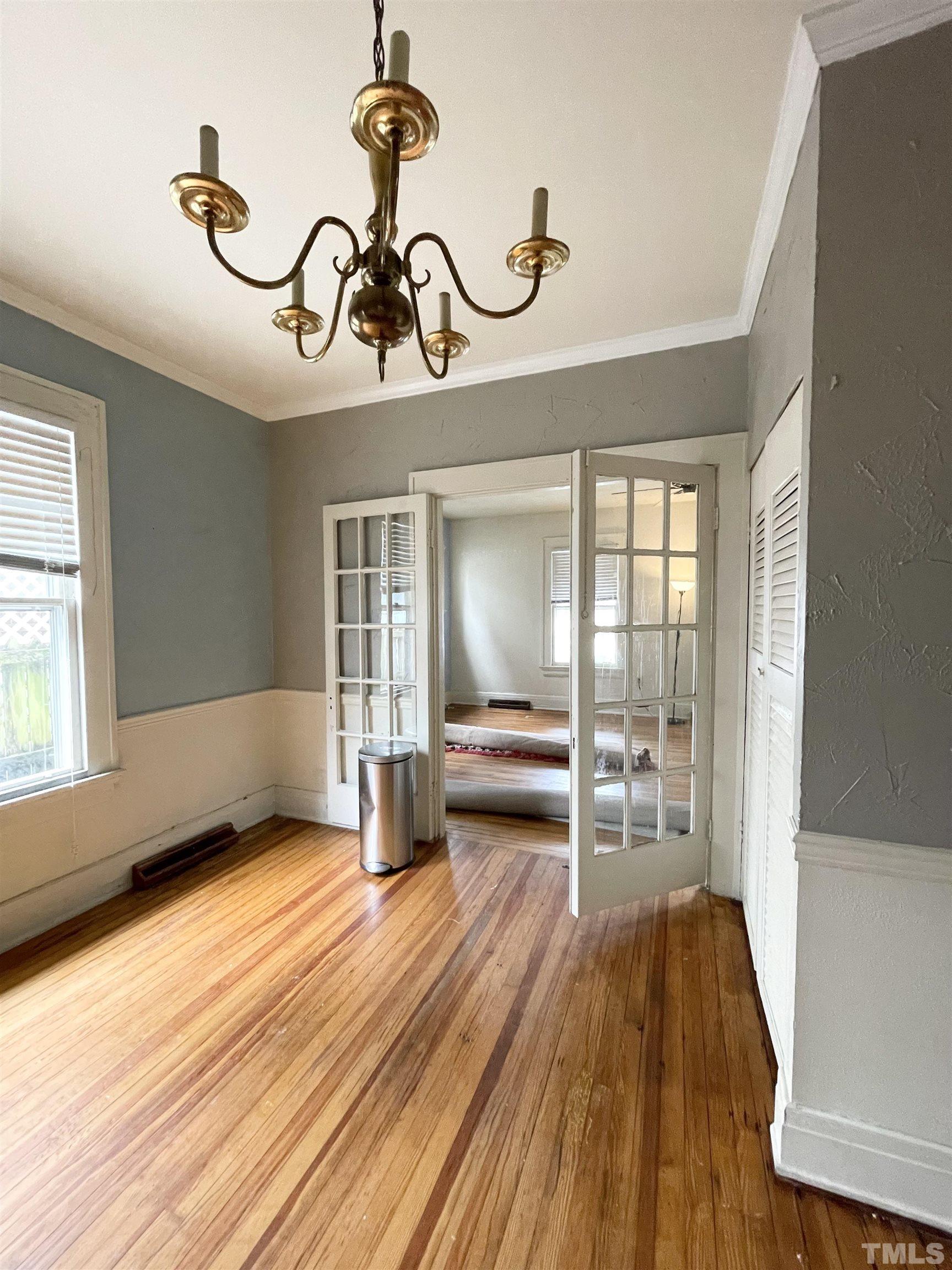 1005 Anderson Street Northwest Wilson, NC 27893 - Photo 4 of 16 a view of a room with wooden floor and a ceiling fan