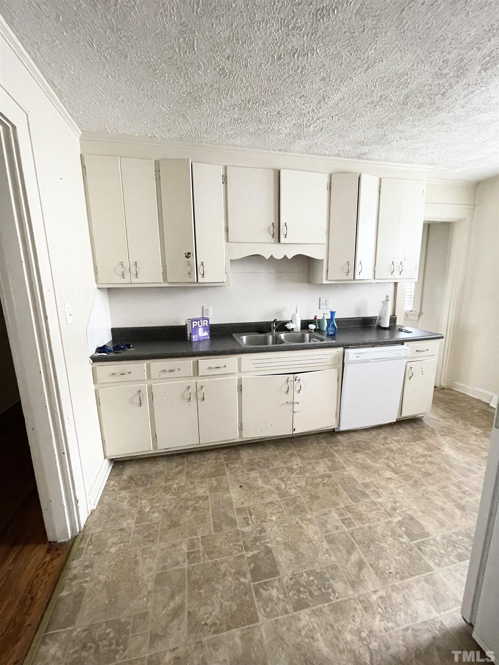 1005 Anderson Street Northwest Wilson, NC 27893 - Photo 5 of 16 a kitchen with stainless steel appliances a sink a stove a refrigerator a window