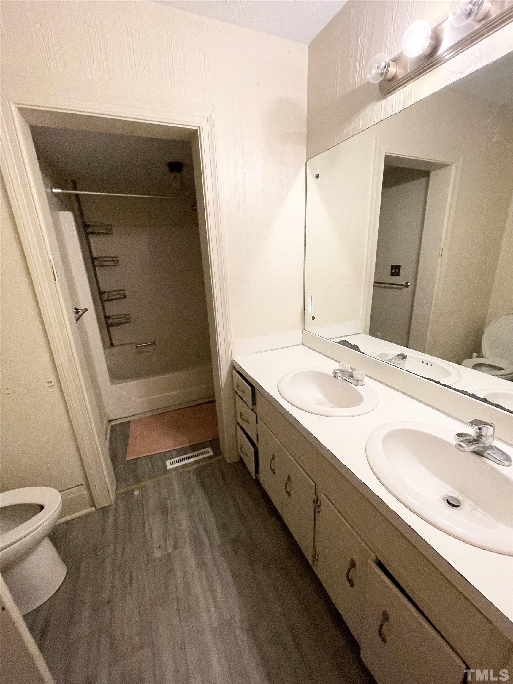 1005 Anderson Street Northwest Wilson, NC 27893 - Photo 7 of 16 a bathroom with a double vanity sink mirror and toilet