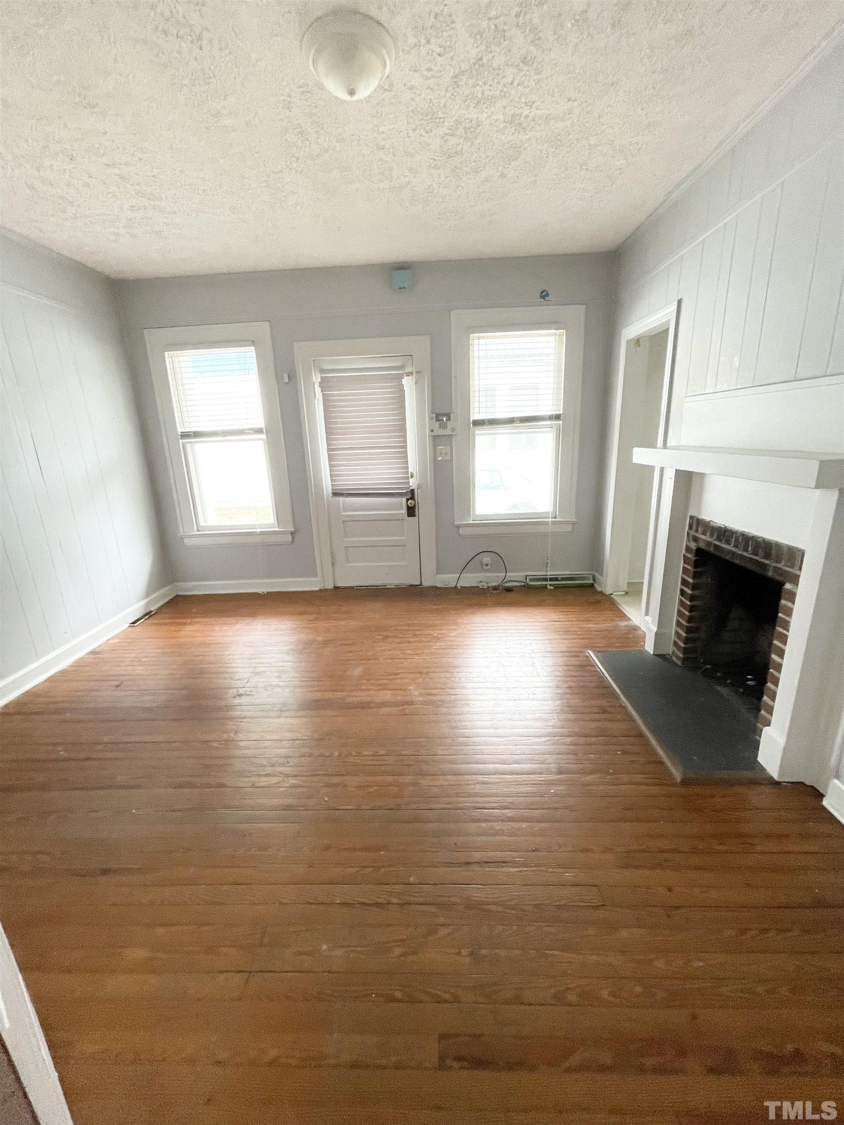 1005 Anderson Street Northwest Wilson, NC 27893 - Photo 8 of 16 a view of empty room with window and fireplace