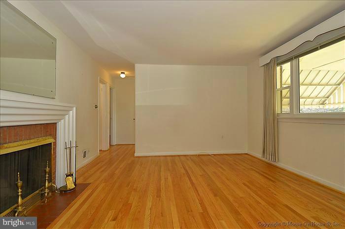 1005 Forest Glen Road Silver Spring, MD 20901 - Photo 2 of 26 a view of empty room with wooden floor and fireplace