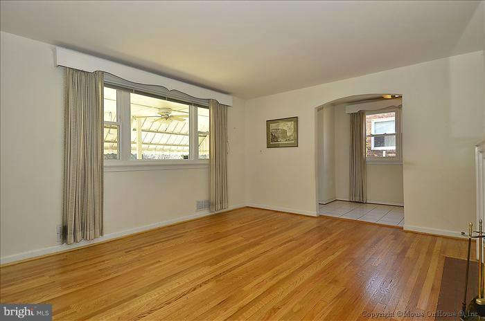 1005 Forest Glen Road Silver Spring, MD 20901 - Photo 17 of 26 a view of an empty room with wooden floor and a window