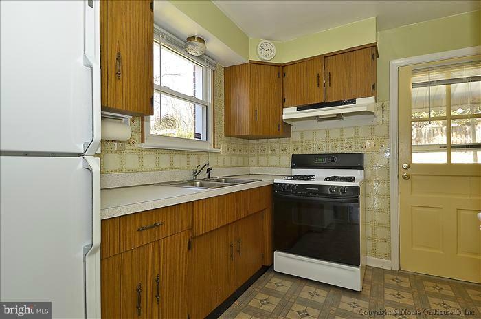 1005 Forest Glen Road Silver Spring, MD 20901 - Photo 19 of 26 a kitchen with a sink stove and cabinets
