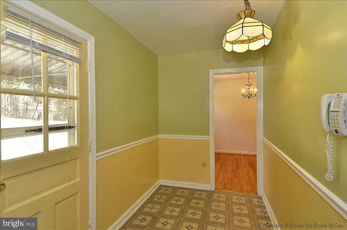 1005 Forest Glen Road Silver Spring, MD 20901 - Photo 24 of 26 a view of a hallway with wooden floor and a window