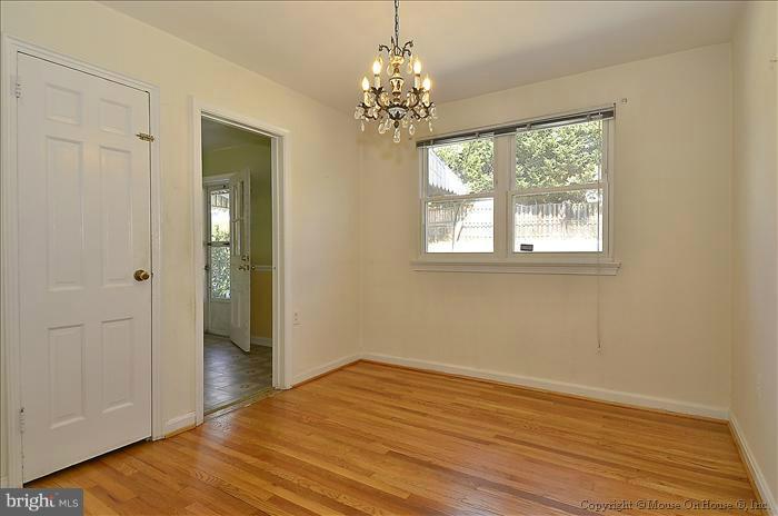 1005 Forest Glen Road Silver Spring, MD 20901 - Photo 6 of 26 an empty room with wooden floor and windows