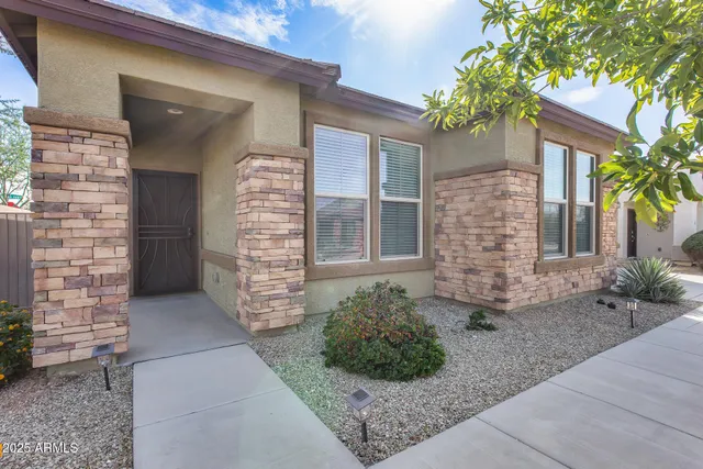 an empty room with wooden floor and a ceiling fan