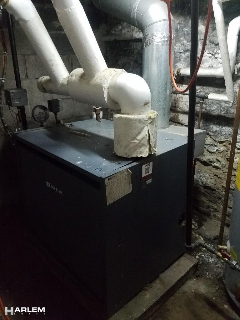 30 Edgecombe Avenue Manhattan, NY 10030 - Photo 11 of 16 a kitchen with a sink stainless steel appliances and cabinets