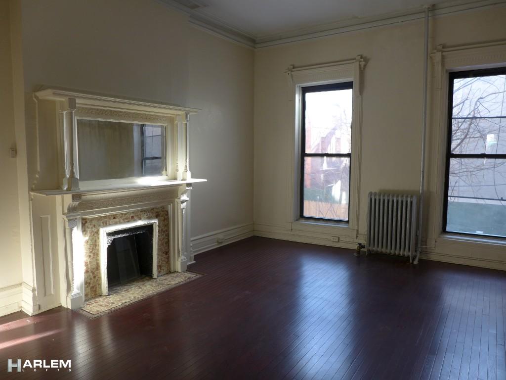 30 Edgecombe Avenue Manhattan, NY 10030 - Photo 4 of 16 an empty room with wooden floor fireplace and windows