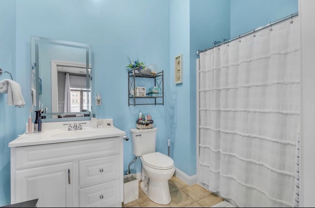 7 Central Square, Unit 307 Lynn, MA 01901 - Photo 8 of 9 a bathroom with a sink a toilet and shower