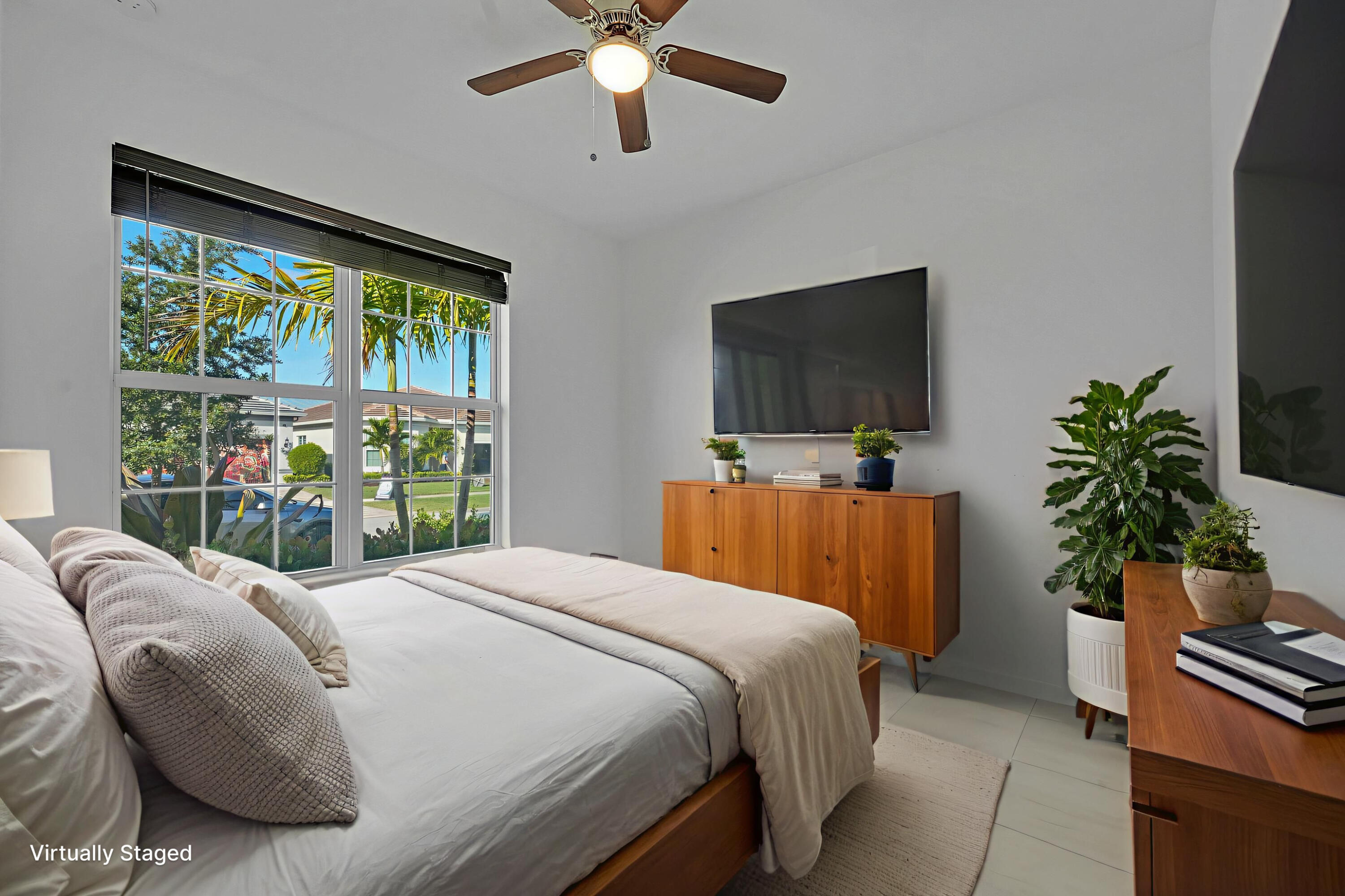 9765 Southwest Meridian Way Stuart, FL 34997 - Photo 17 of 46 a bedroom with a bed and a flat screen tv