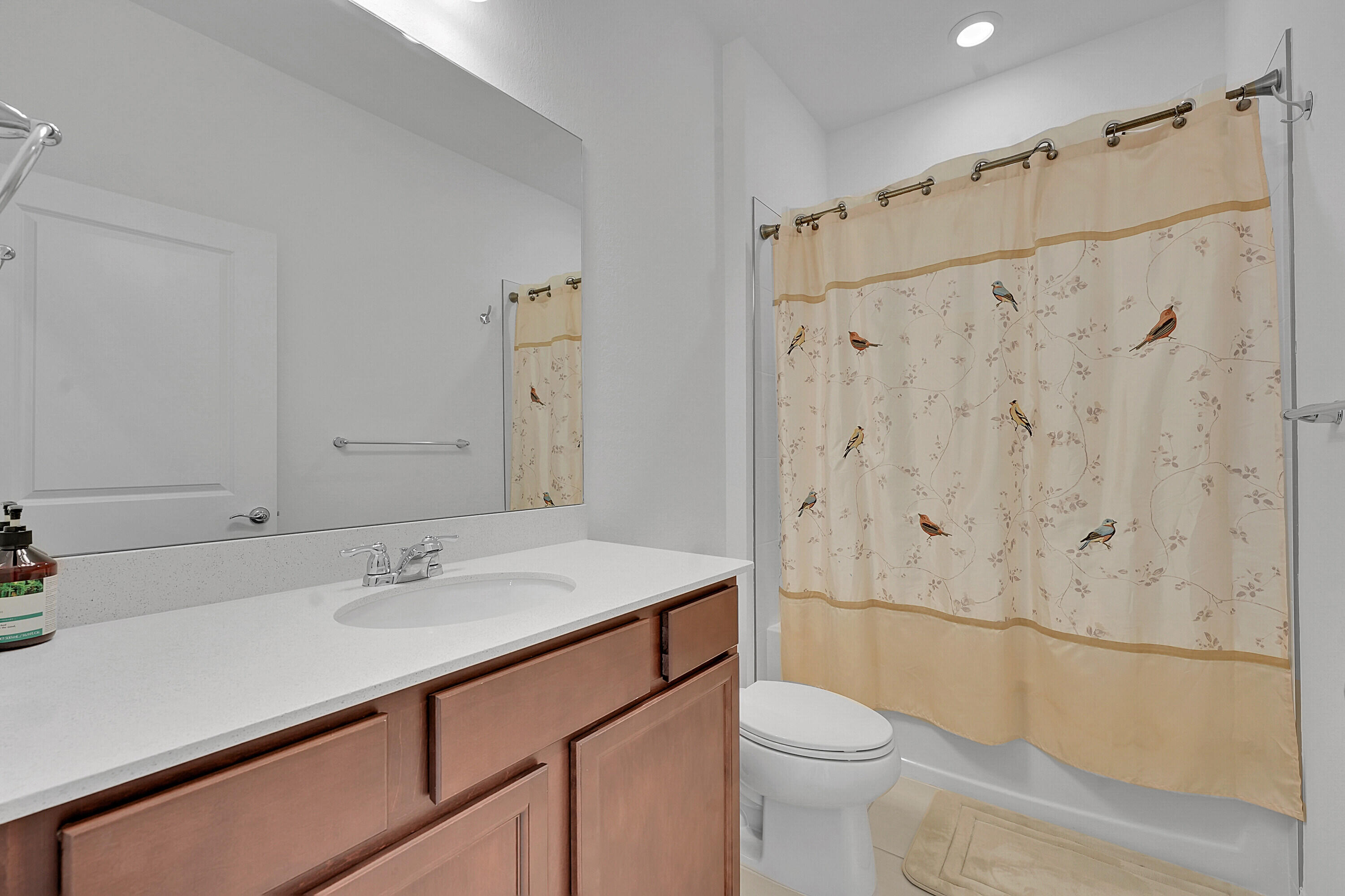 9765 Southwest Meridian Way Stuart, FL 34997 - Photo 21 of 46 a bathroom with a sink a toilet and shower