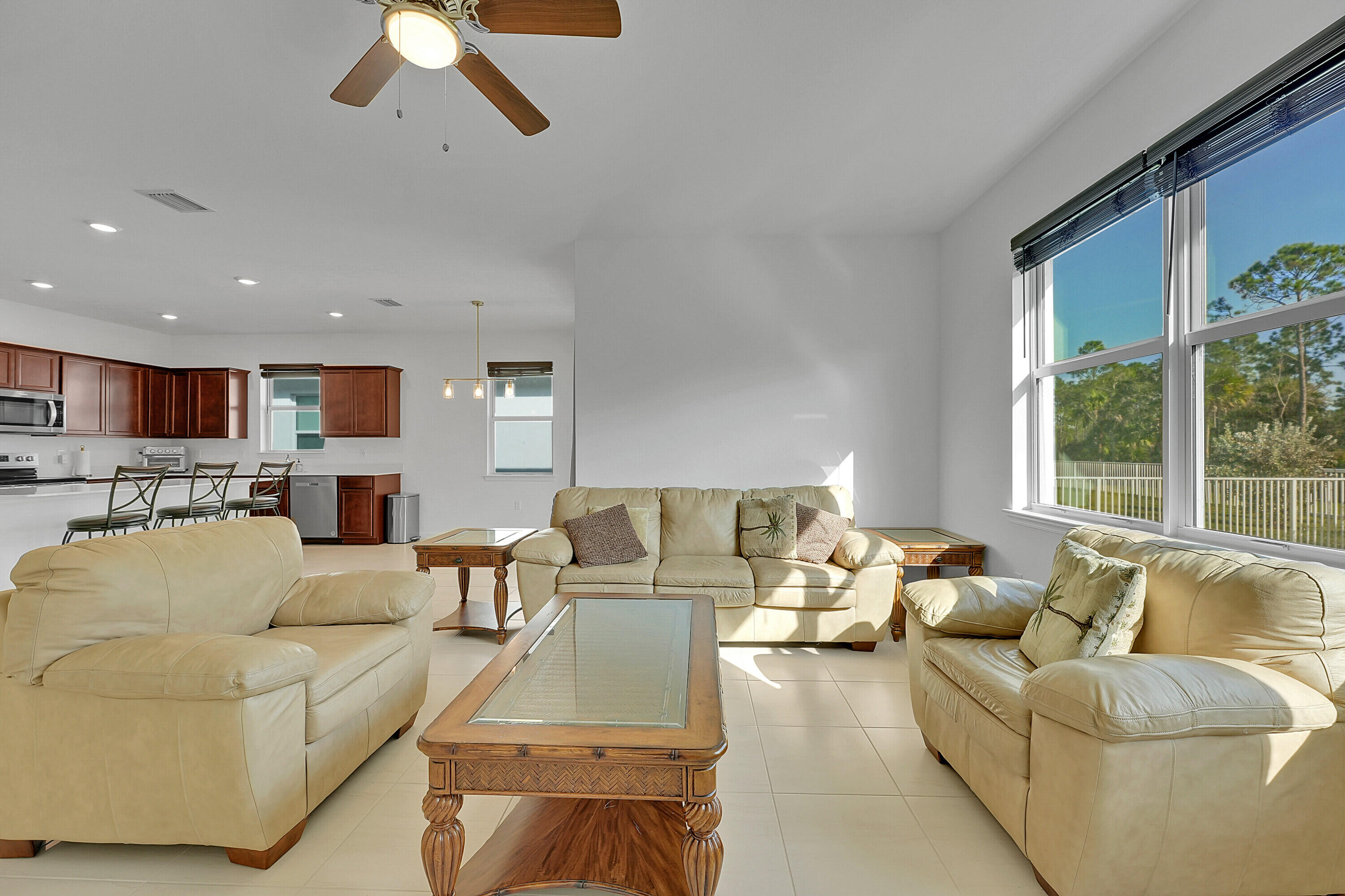 9765 Southwest Meridian Way Stuart, FL 34997 - Photo 6 of 46 a living room with furniture and a large window