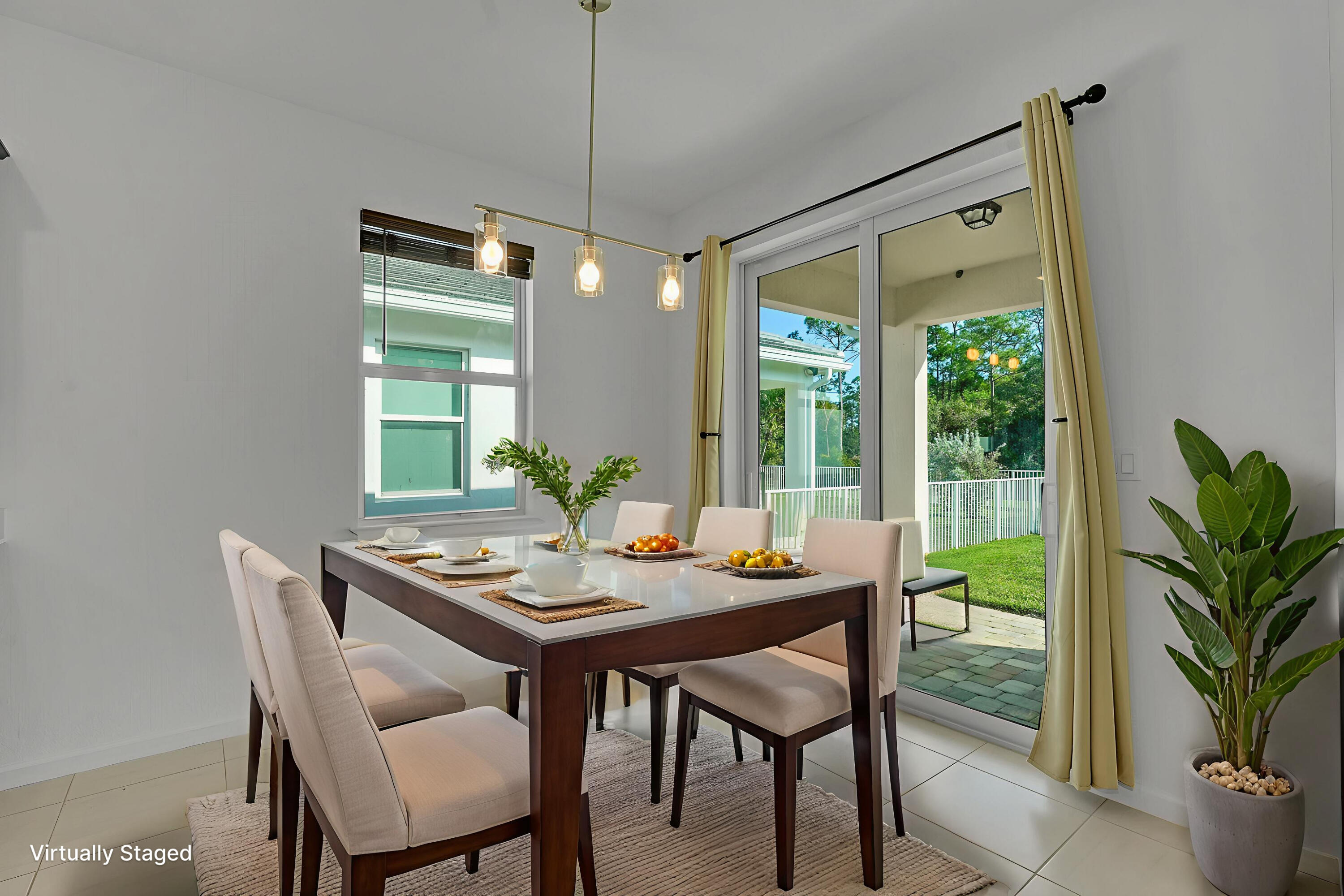 9765 Southwest Meridian Way Stuart, FL 34997 - Photo 10 of 46 a view of a dining room with furniture window and outside view