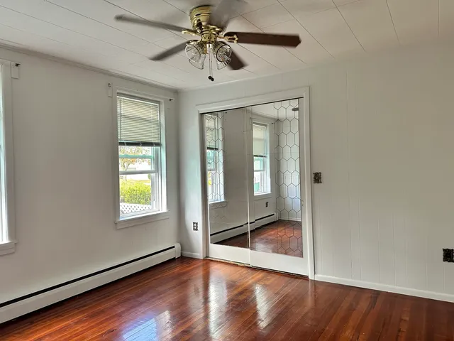 a view of an empty room and wooden floor