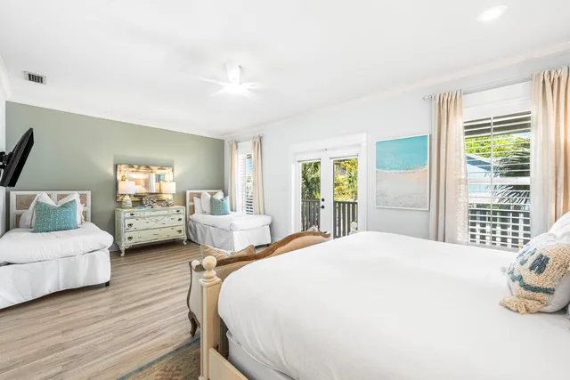 a spacious bedroom with a bed and wooden floor