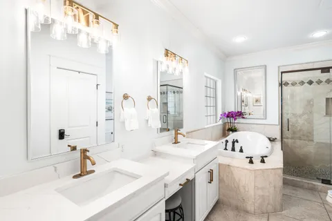 a bathroom with a sink vanity tub and shower