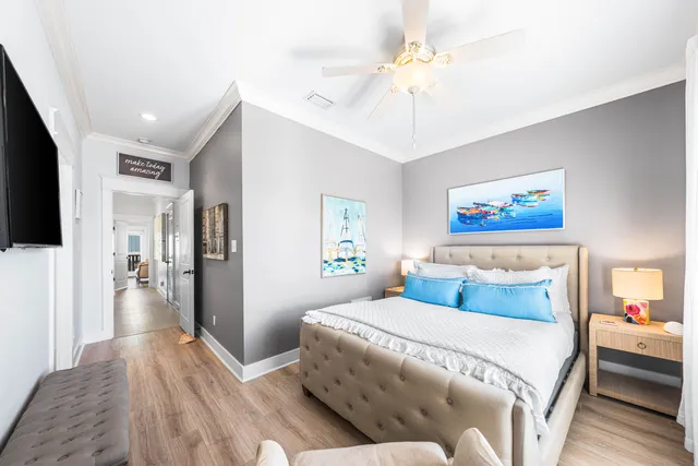 a bedroom with a large bed and a chandelier