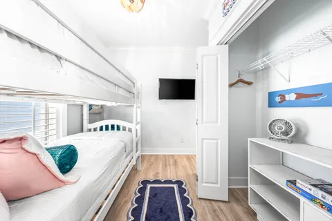 a living room with a bed and a flat screen tv